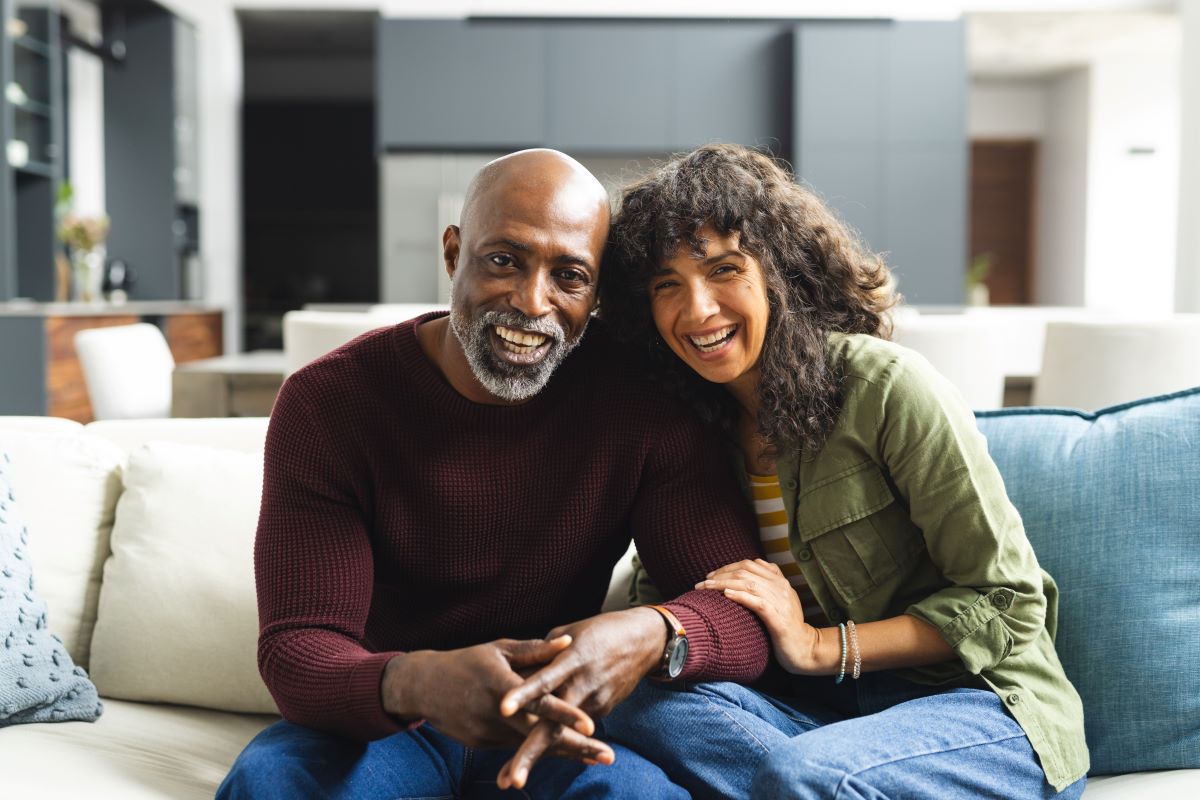 Diverse couple sitting on a  couch